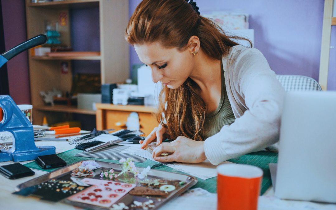 Image shows a woman crafting artisan crafts.